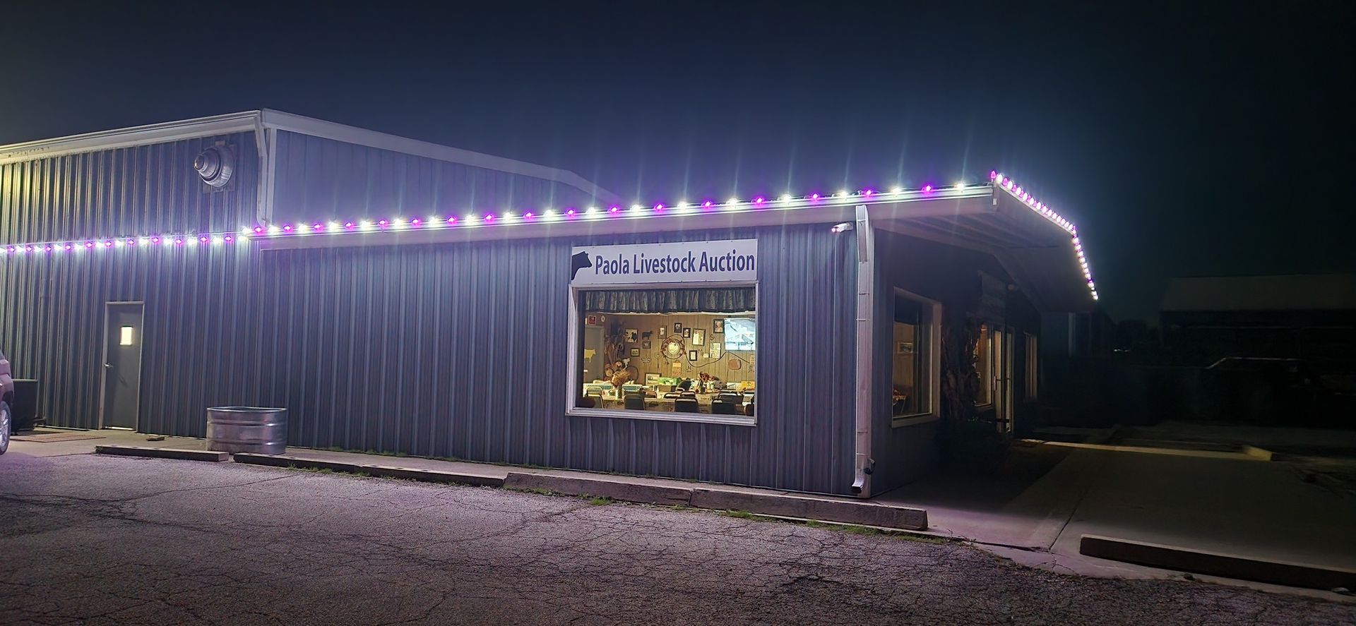 A metal building with string lights and a sign that says Roadside Eatery.