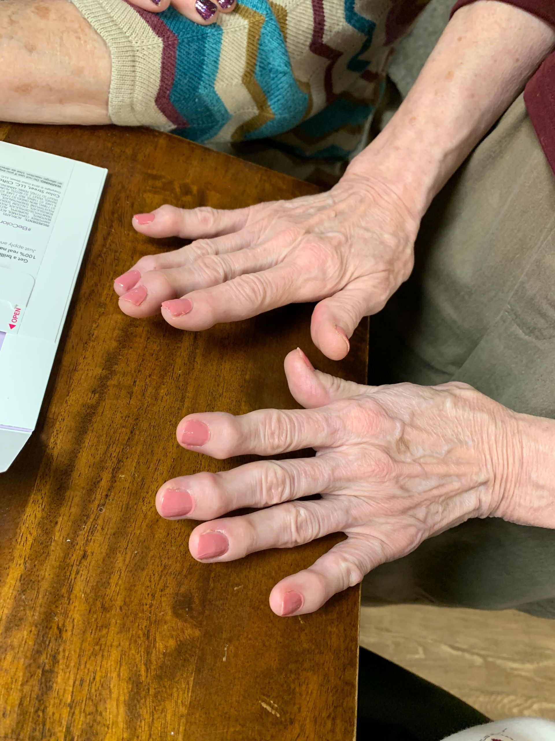 A close up of a person 's hands on a wooden table