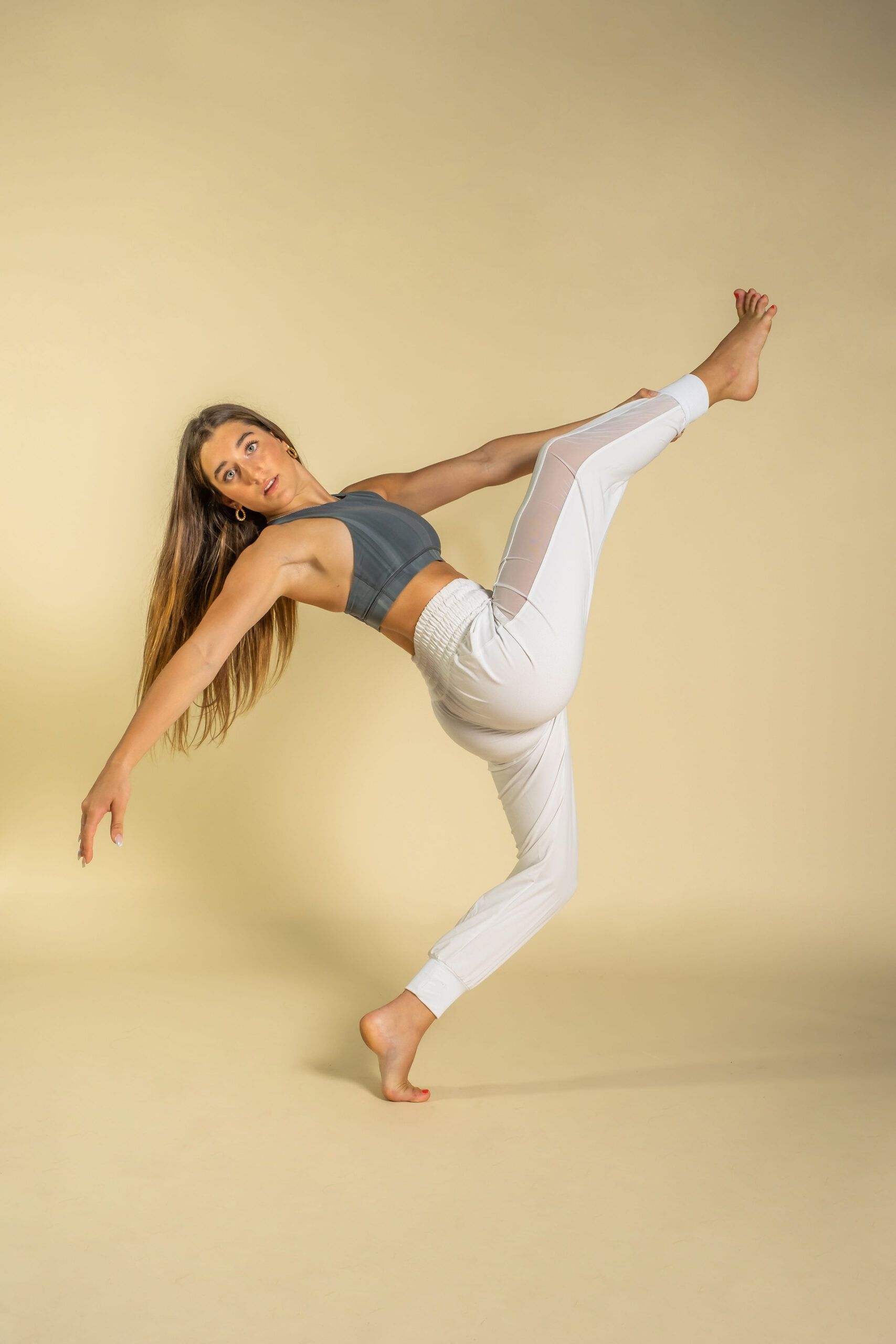 A woman is standing on one leg in a yoga pose.