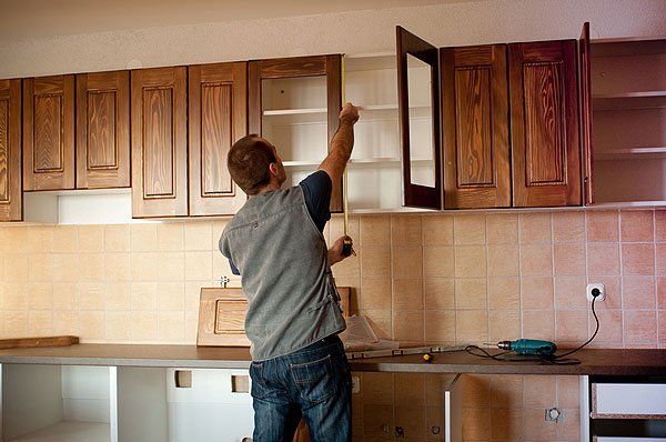 Man installing cabinet