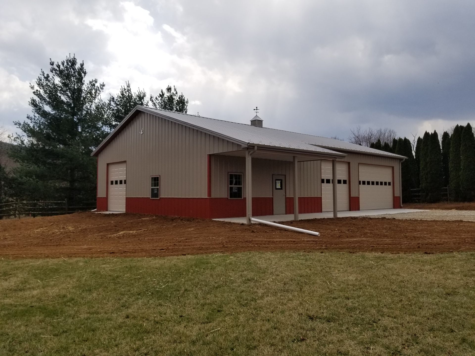 A large building with a porch and garage doors