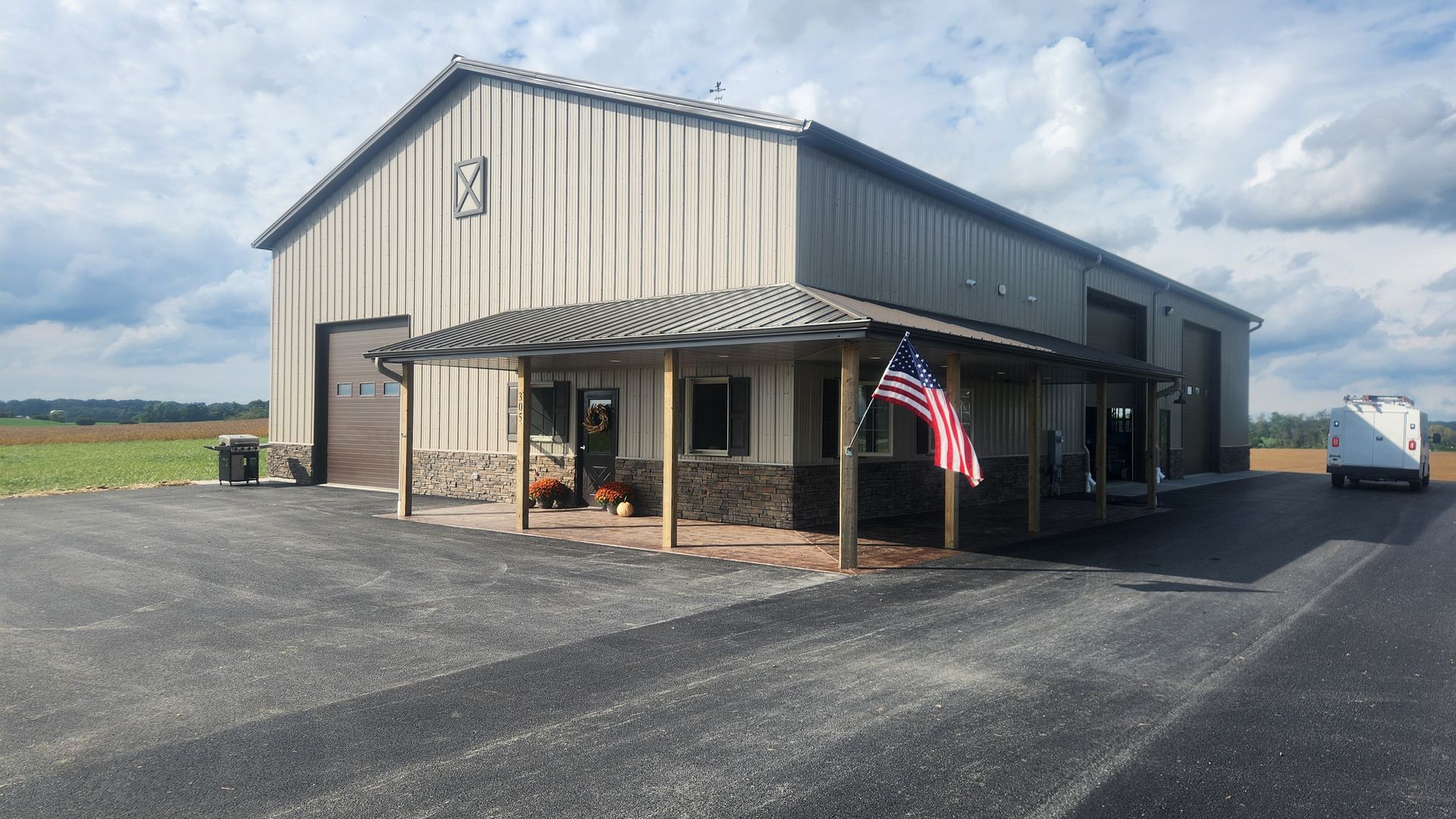 A large building with an american flag on the porch.