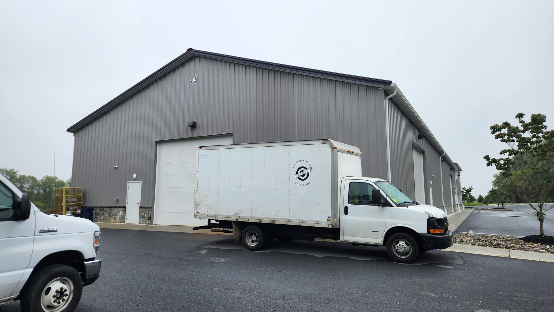 A white van is parked in front of a building