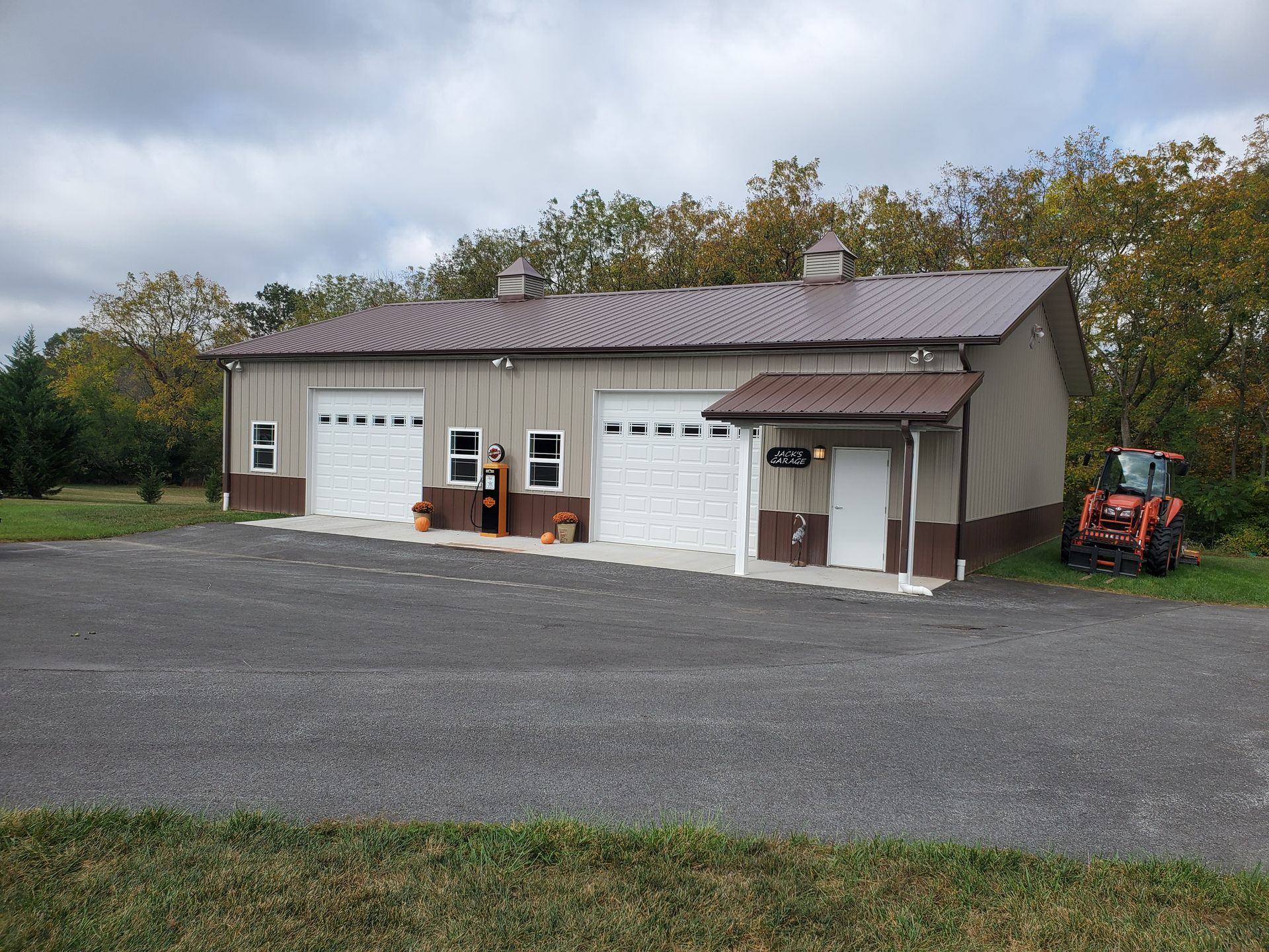A garage with a tractor parked in front of it
