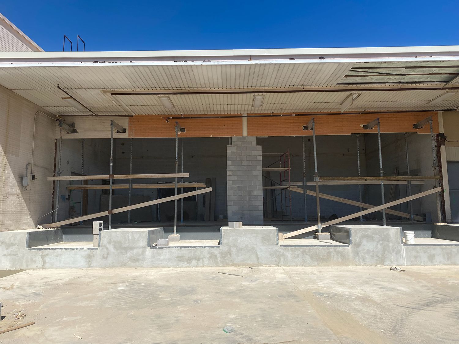A building under construction with scaffolding in front of it.