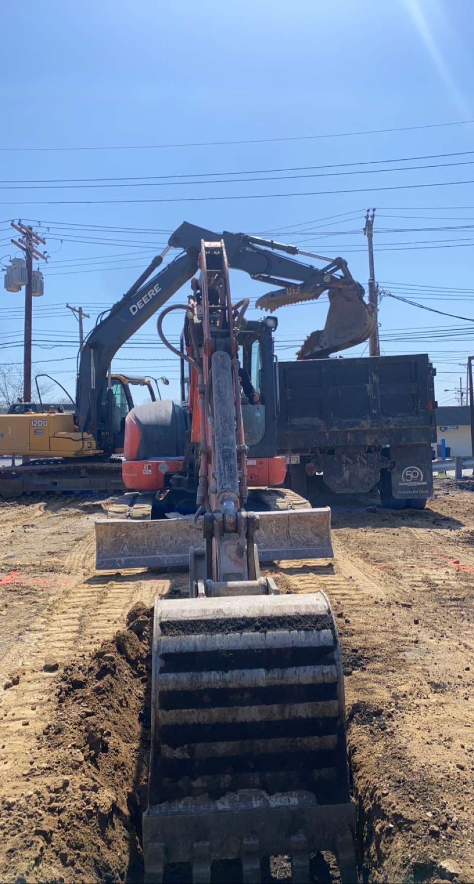 A bulldozer is digging a hole in the dirt in a construction site.