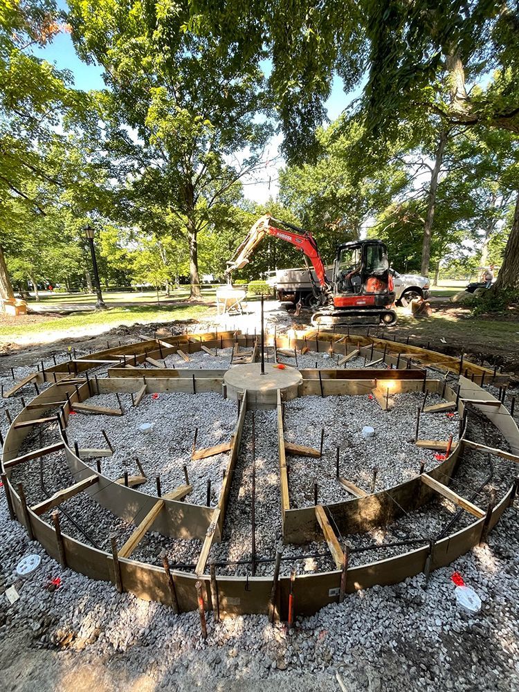 A large circular structure is being built in a park.