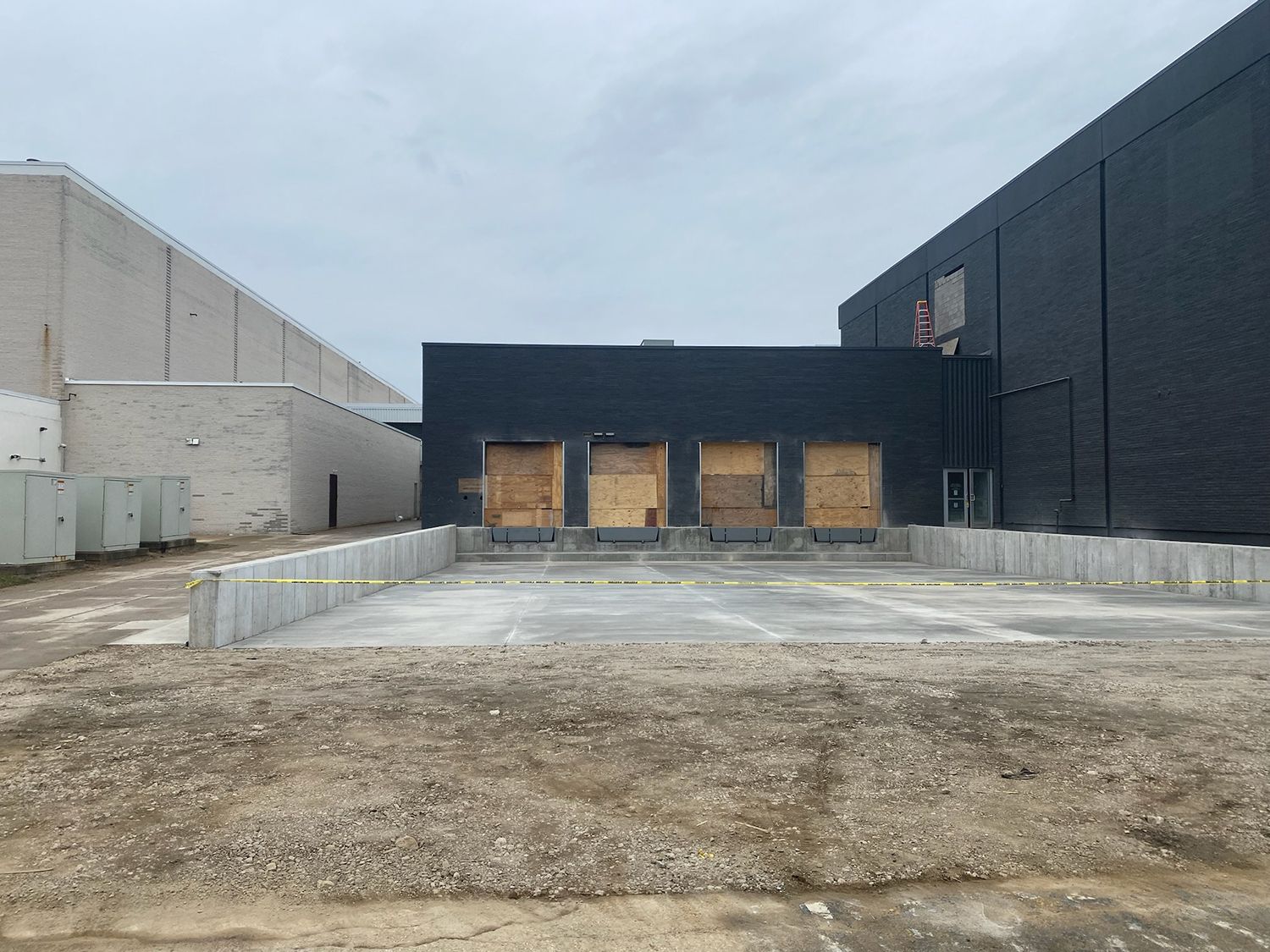 A large building with a lot of loading docks in front of it.