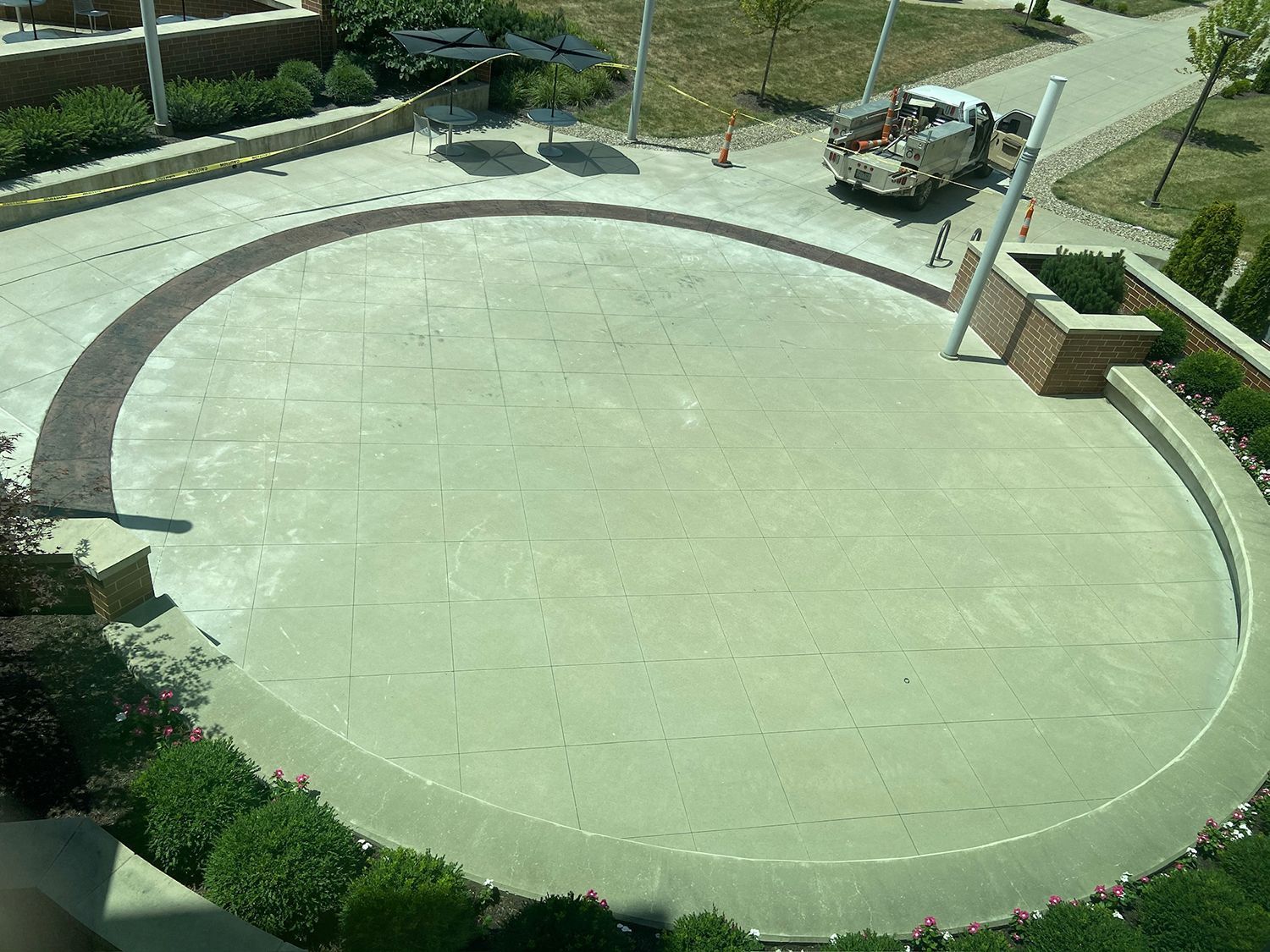 A truck is parked in the middle of a circular driveway.