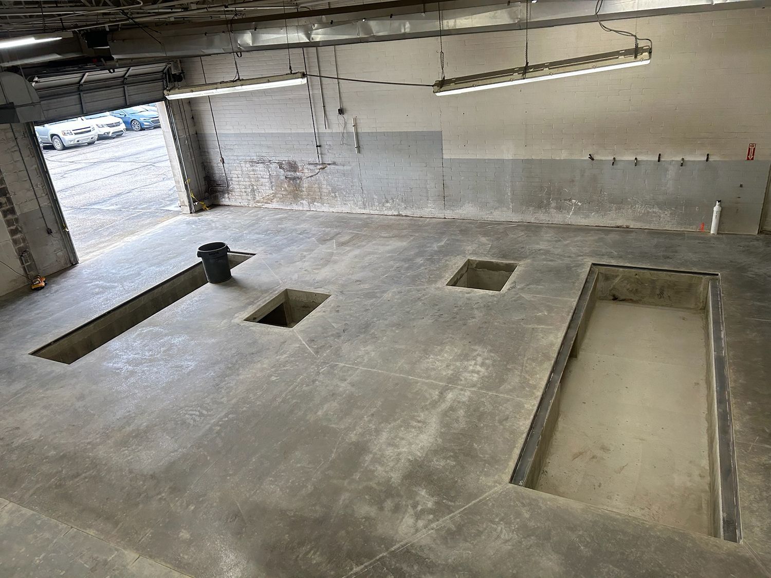 An aerial view of a garage with two holes in the floor.