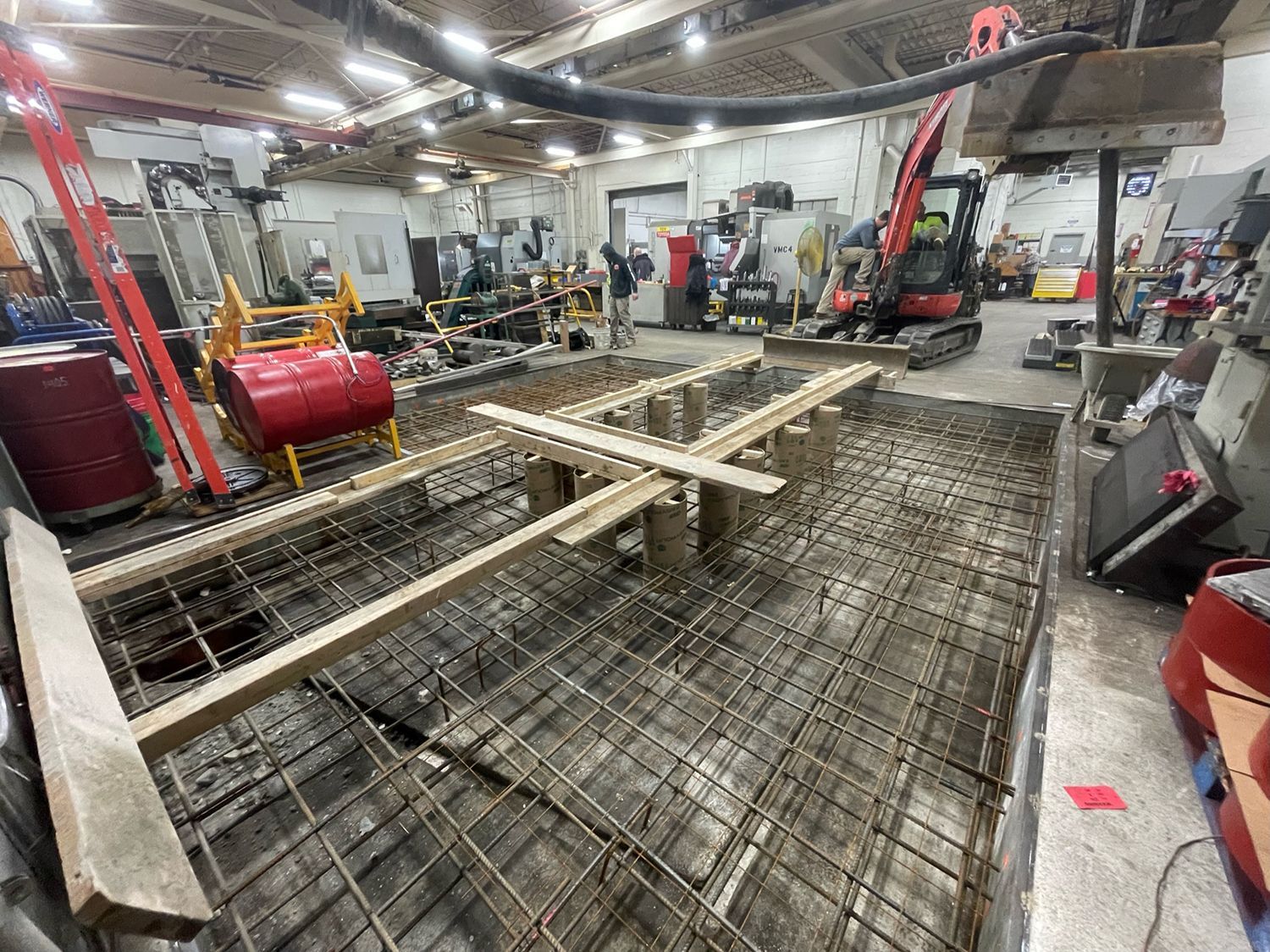 A large room with a lot of machinery and a concrete floor.