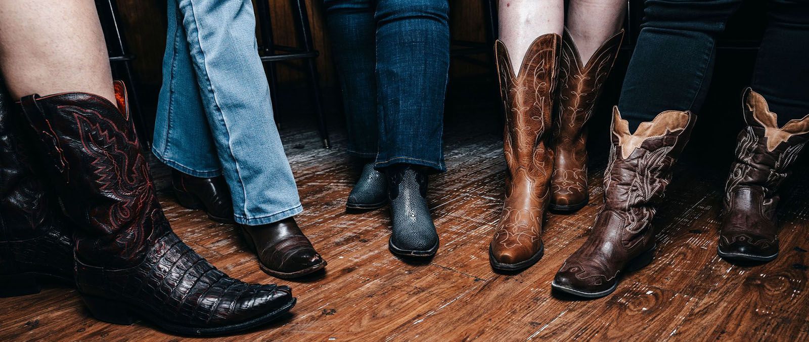 Five women showing their cowboy boots