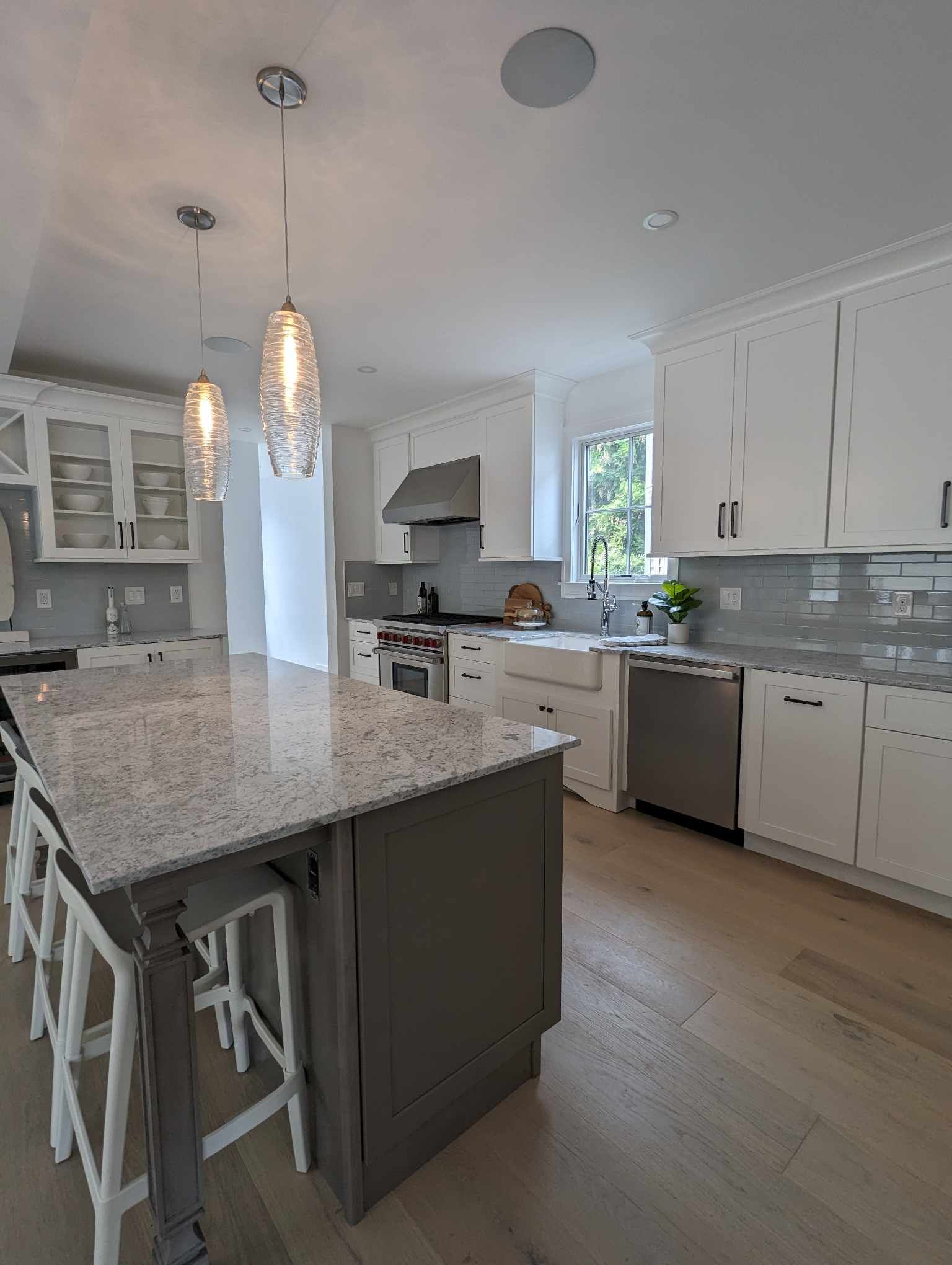 A kitchen with white cabinets and granite counter tops