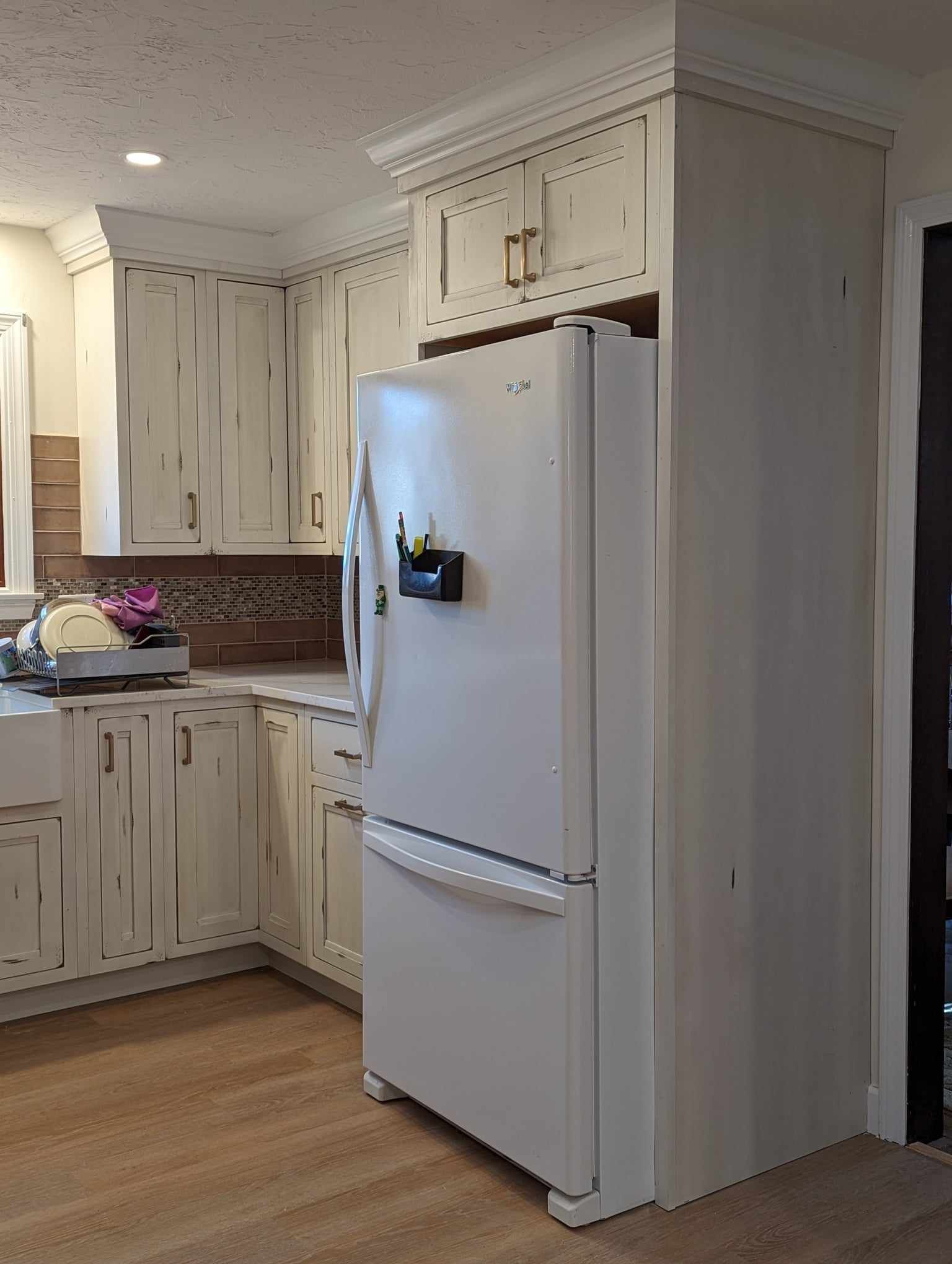 kitchen with white cabinets and a white refrigerator.
