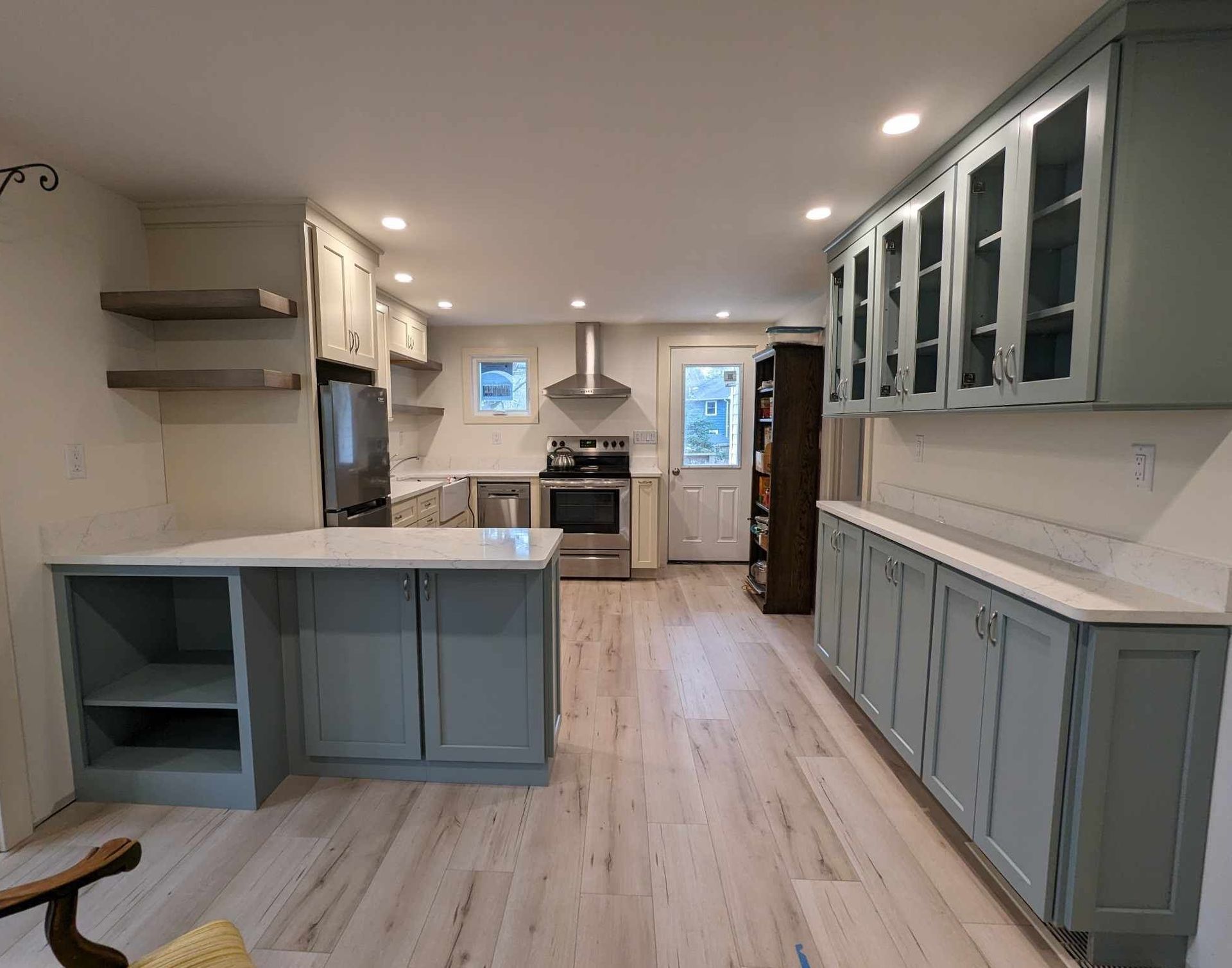 A kitchen with a lot of cabinets and a large island.