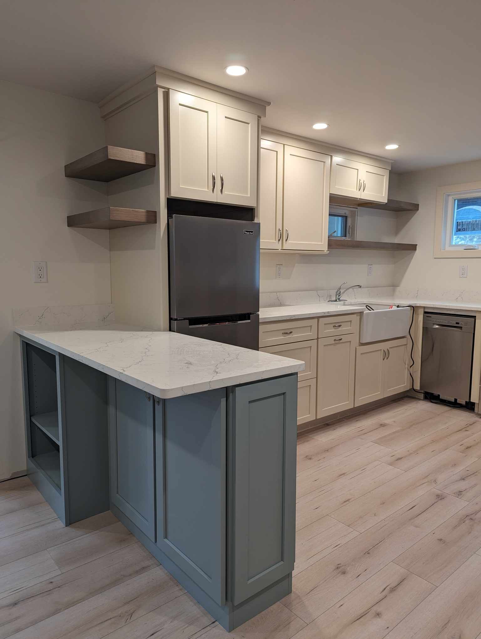 A kitchen with white cabinets and stainless steel appliances.