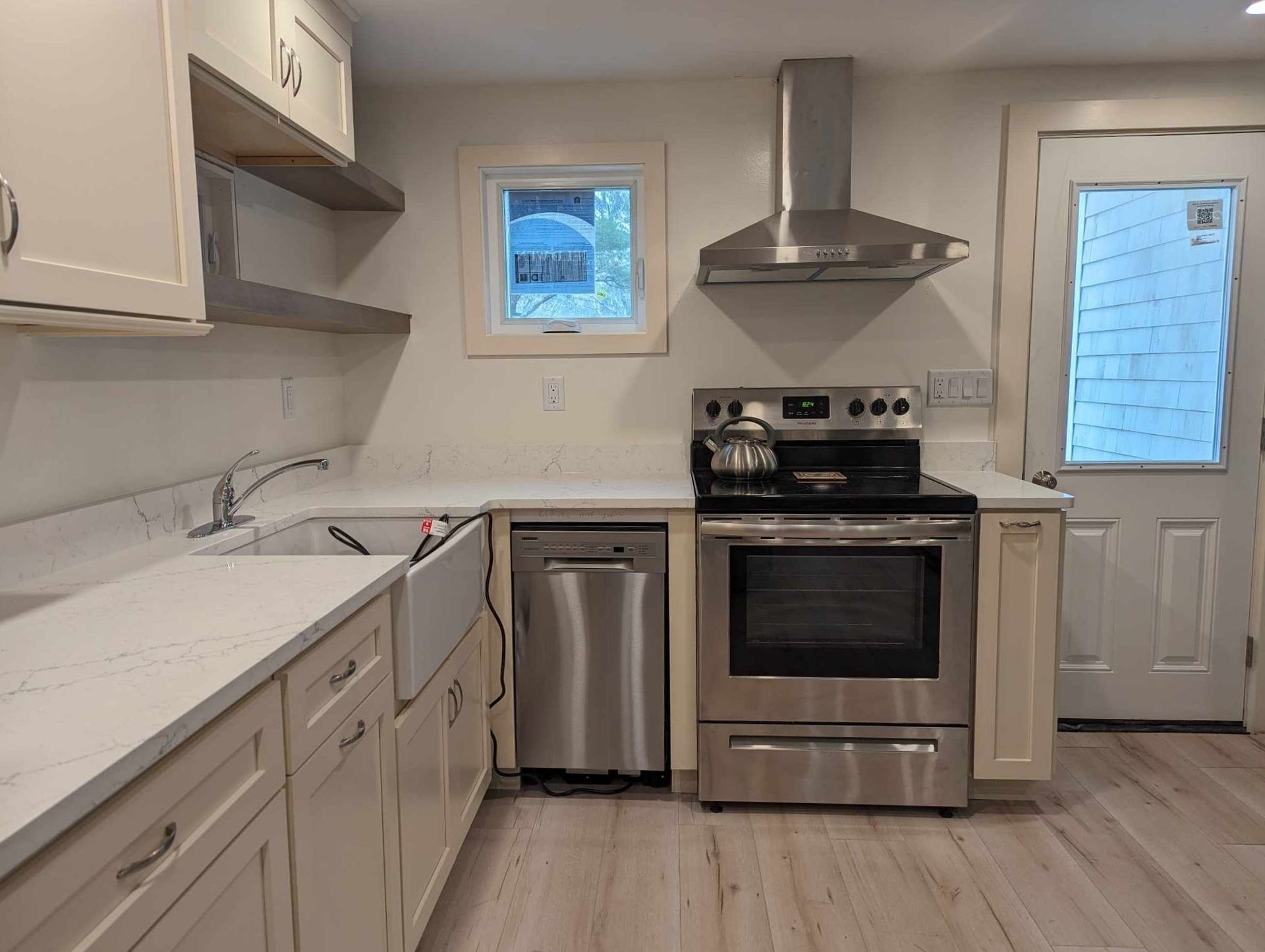 A kitchen with stainless steel appliances and white cabinets