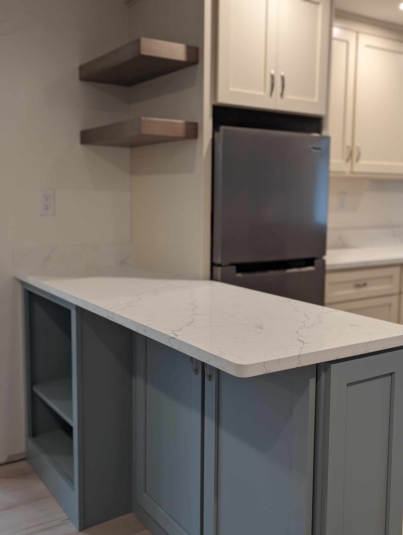 A kitchen with a refrigerator and a counter top