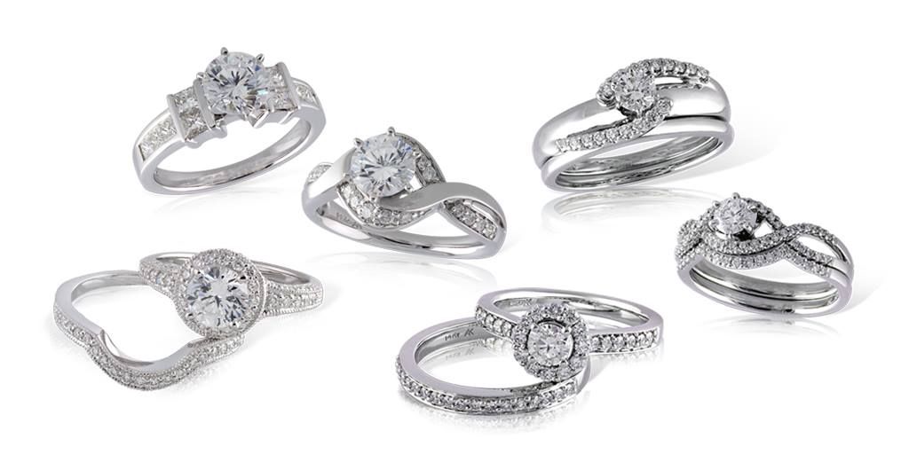 Six diamond engagement rings on a white background, various designs.