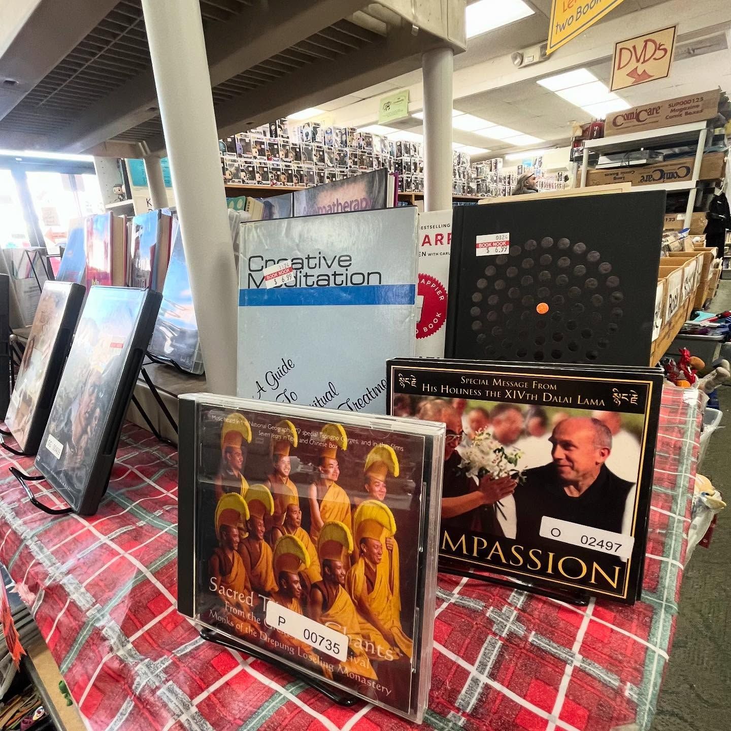 Several cds are sitting on a table including one called mpassion