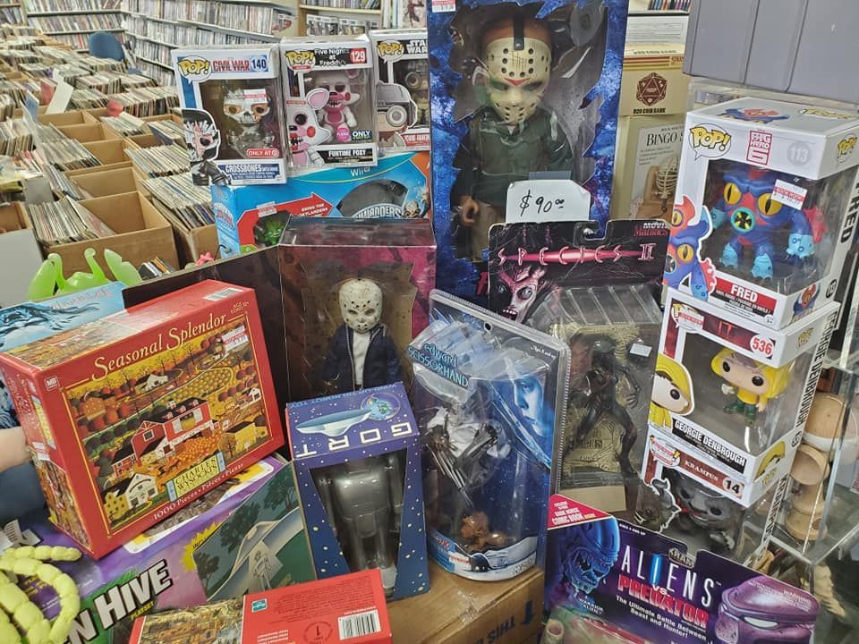 A bunch of toys are stacked on top of each other on a table in a store.