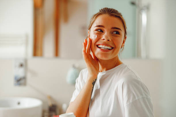 Woman applying skincare products Woman applying skincare products