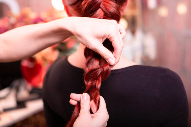 Ooh La Lash Salon stylist creating a beautiful, low-maintenance braided hairstyle. Ooh La Lash Salon stylist creating a beautiful, low-maintenance braided hairstyle.