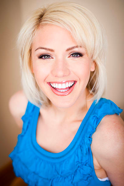 a happy Ooh La Lash and Beauty client with healthy, glowing skin.