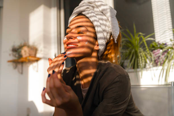 Woman applying skincare products for radiant skin Woman applying skincare products for radiant skin