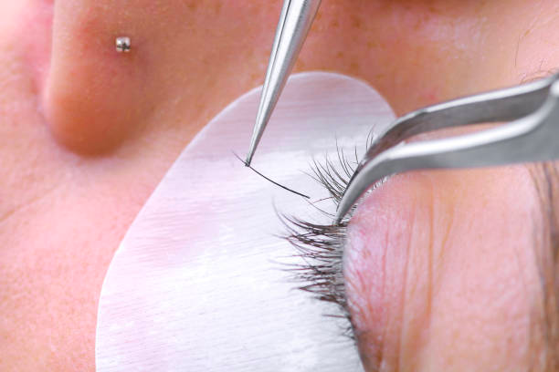 Close-up of eyelash extension application Close-up of eyelash extension application