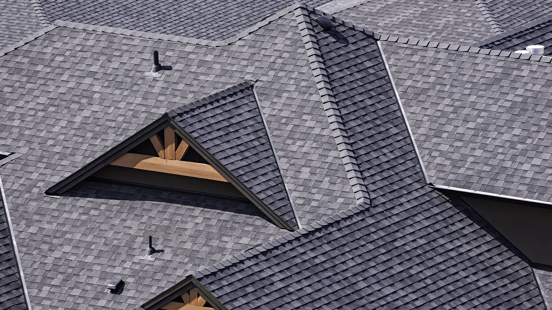 A close up of a roof with a lot of shingles on it.