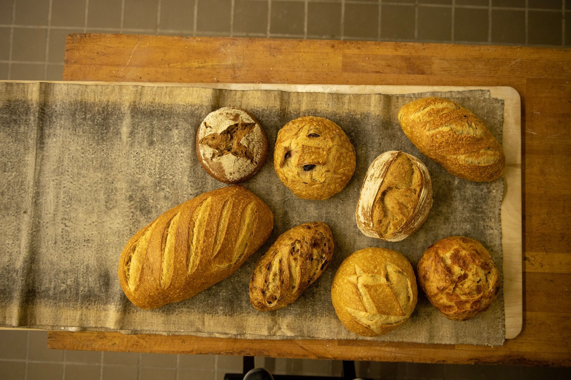 There are many different types of bread on the table.