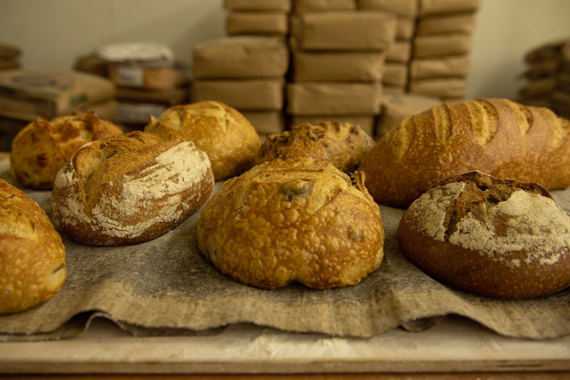There are many different types of bread on the table.