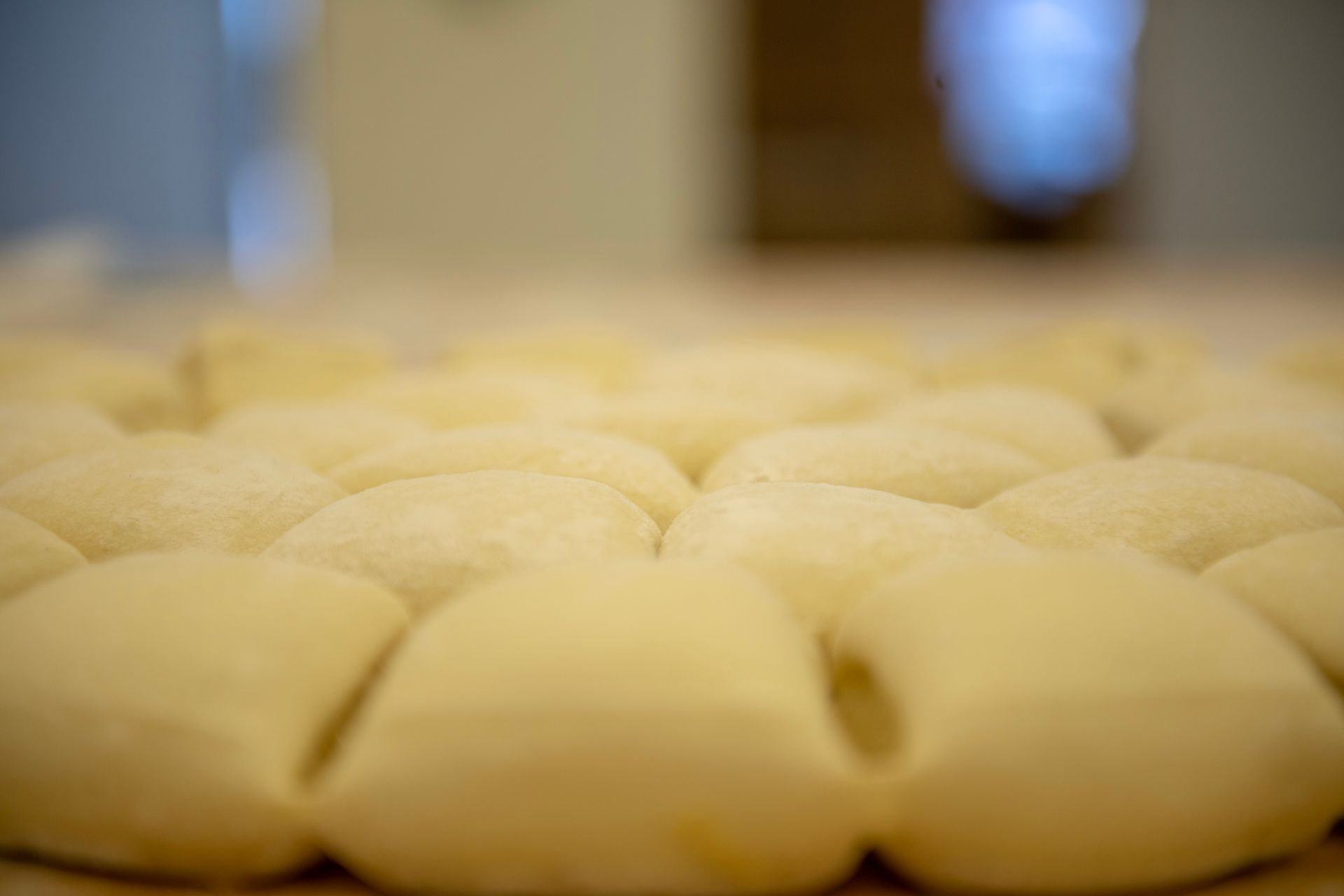A bunch of dough is sitting on top of a wooden table.