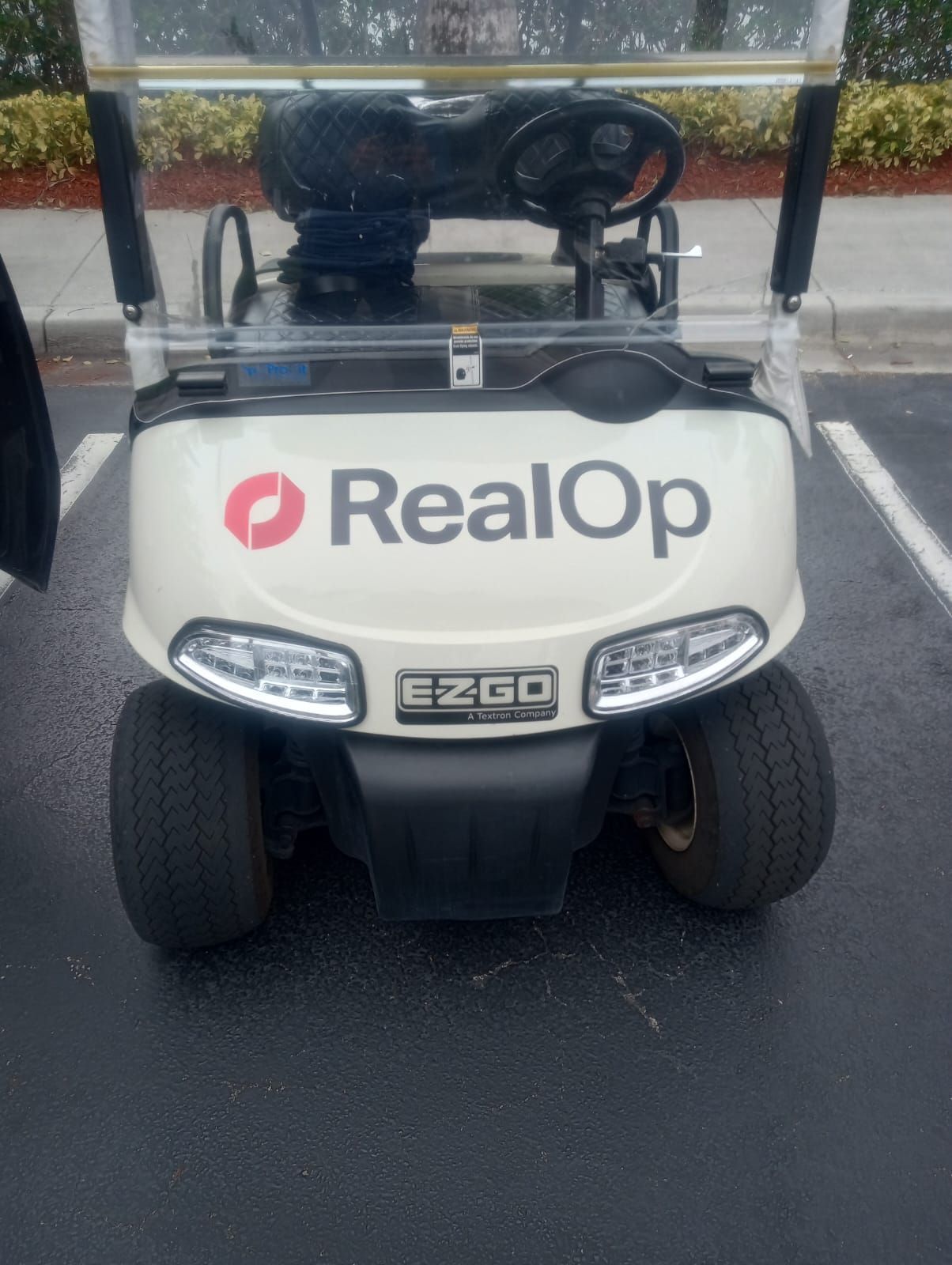 A beige E-Z-GO golf cart with a 