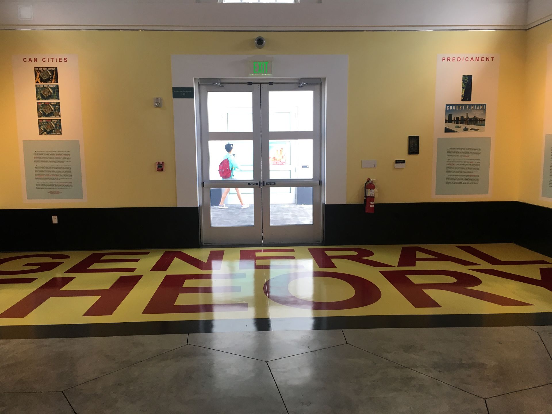 A doorway in a room with yellow walls and the words 