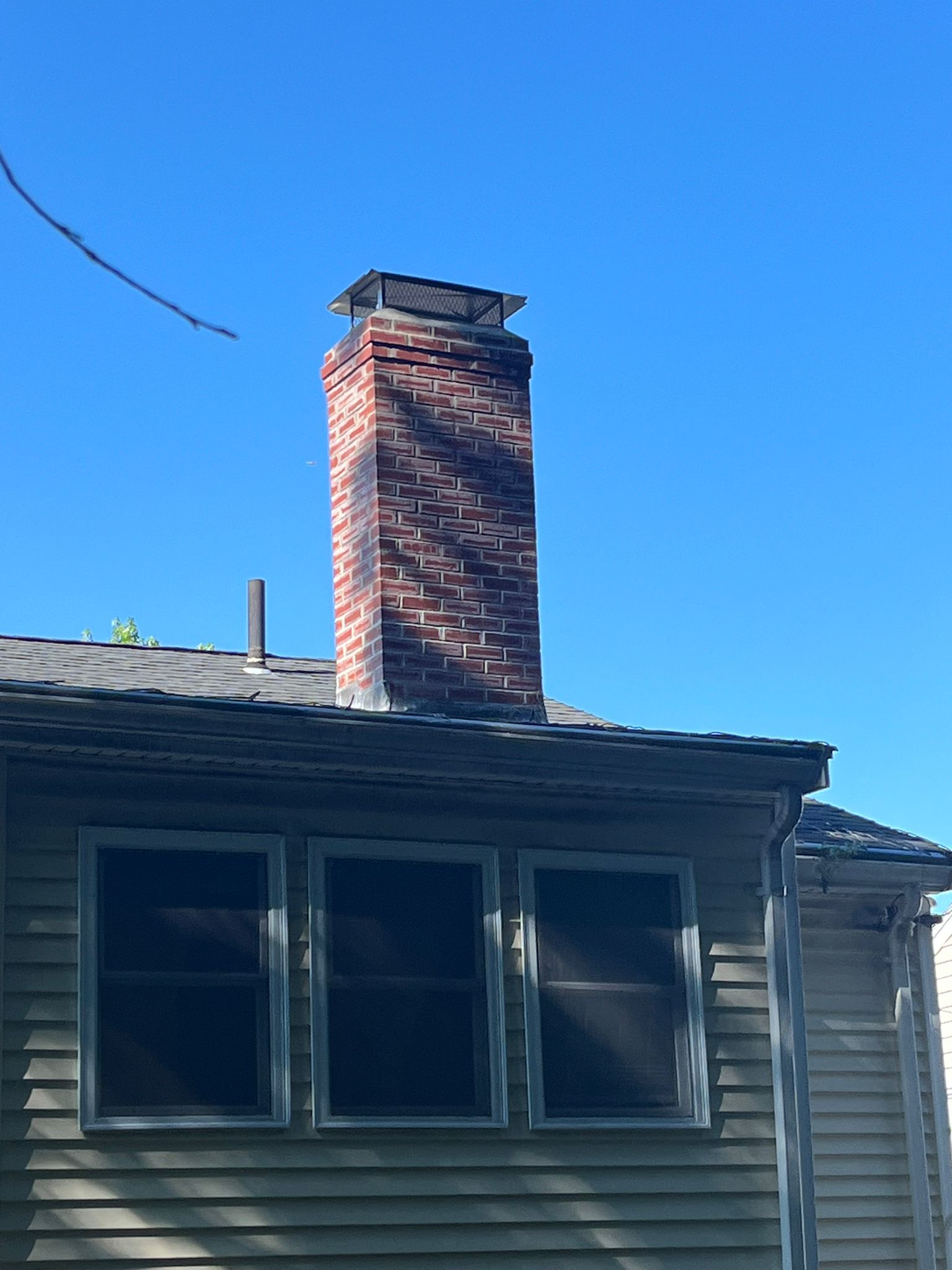 A house with a brick chimney on top of it