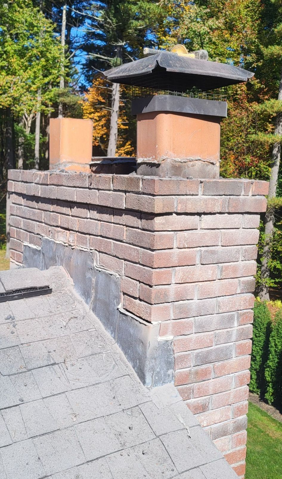 A picture of a chimney on a brick wall on a phone