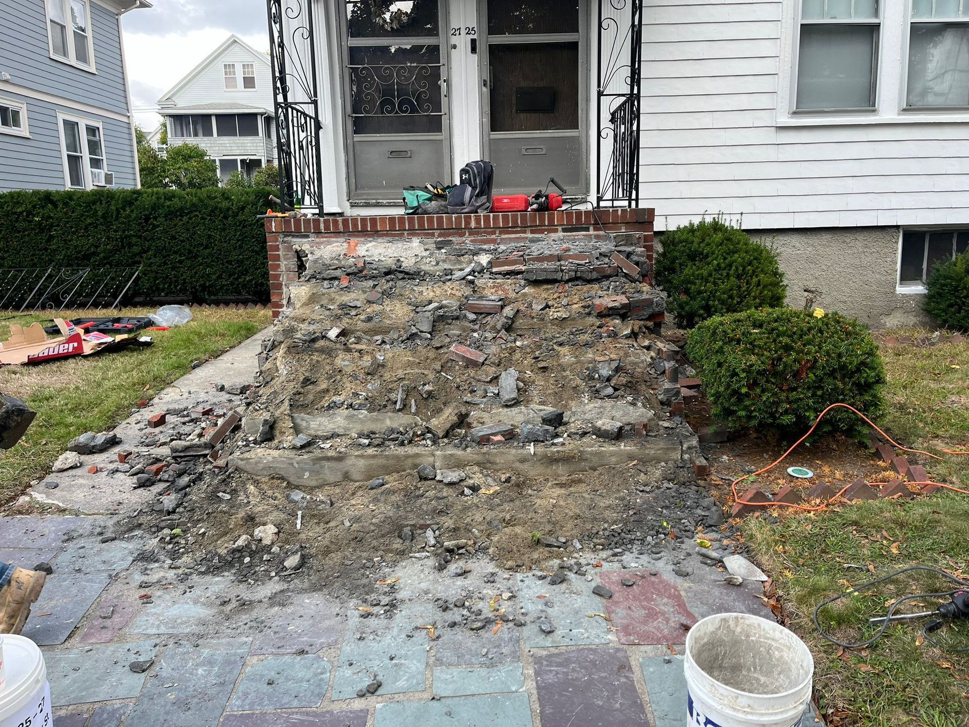 The front steps of a house are being demolished