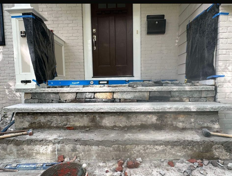 The front porch of a house is being remodeled