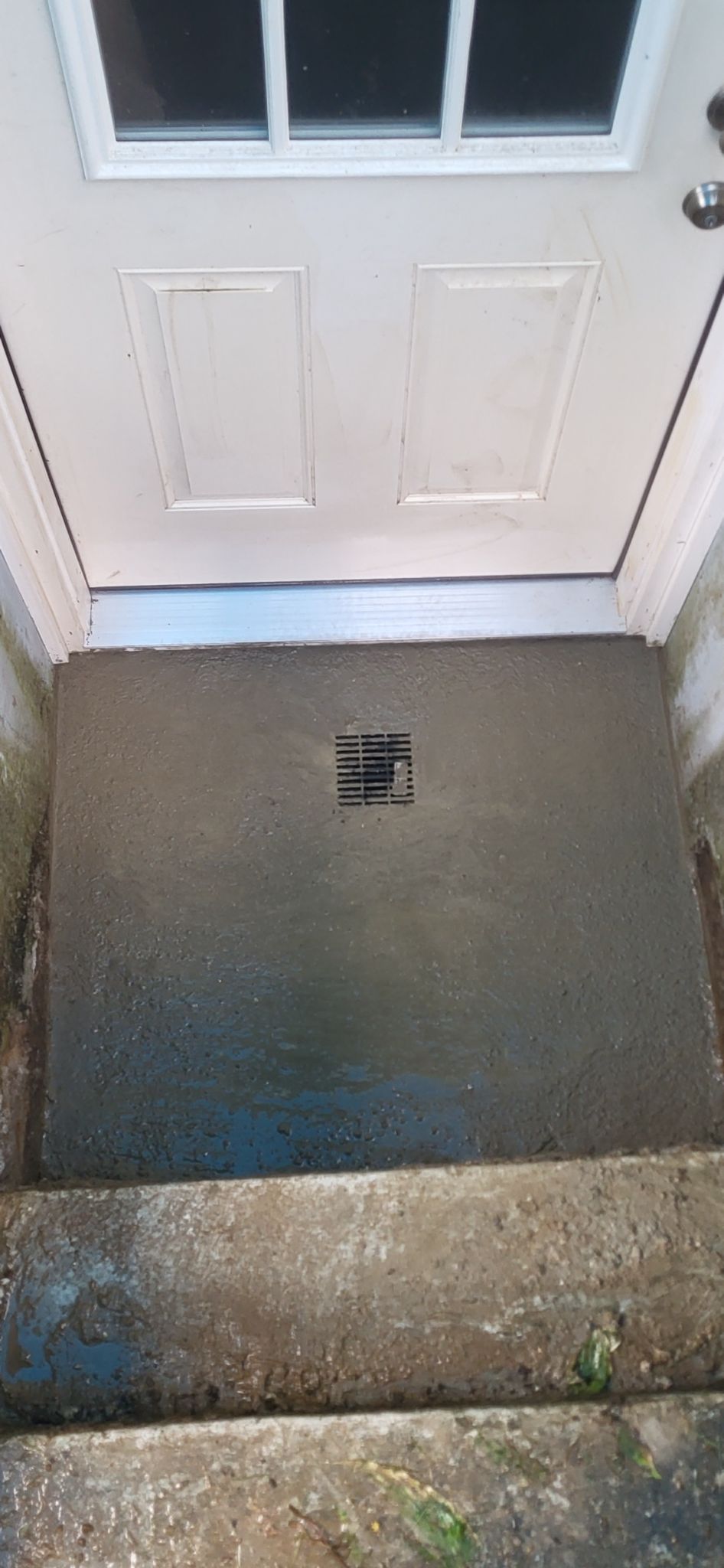 A close up of a door with a door mat on it