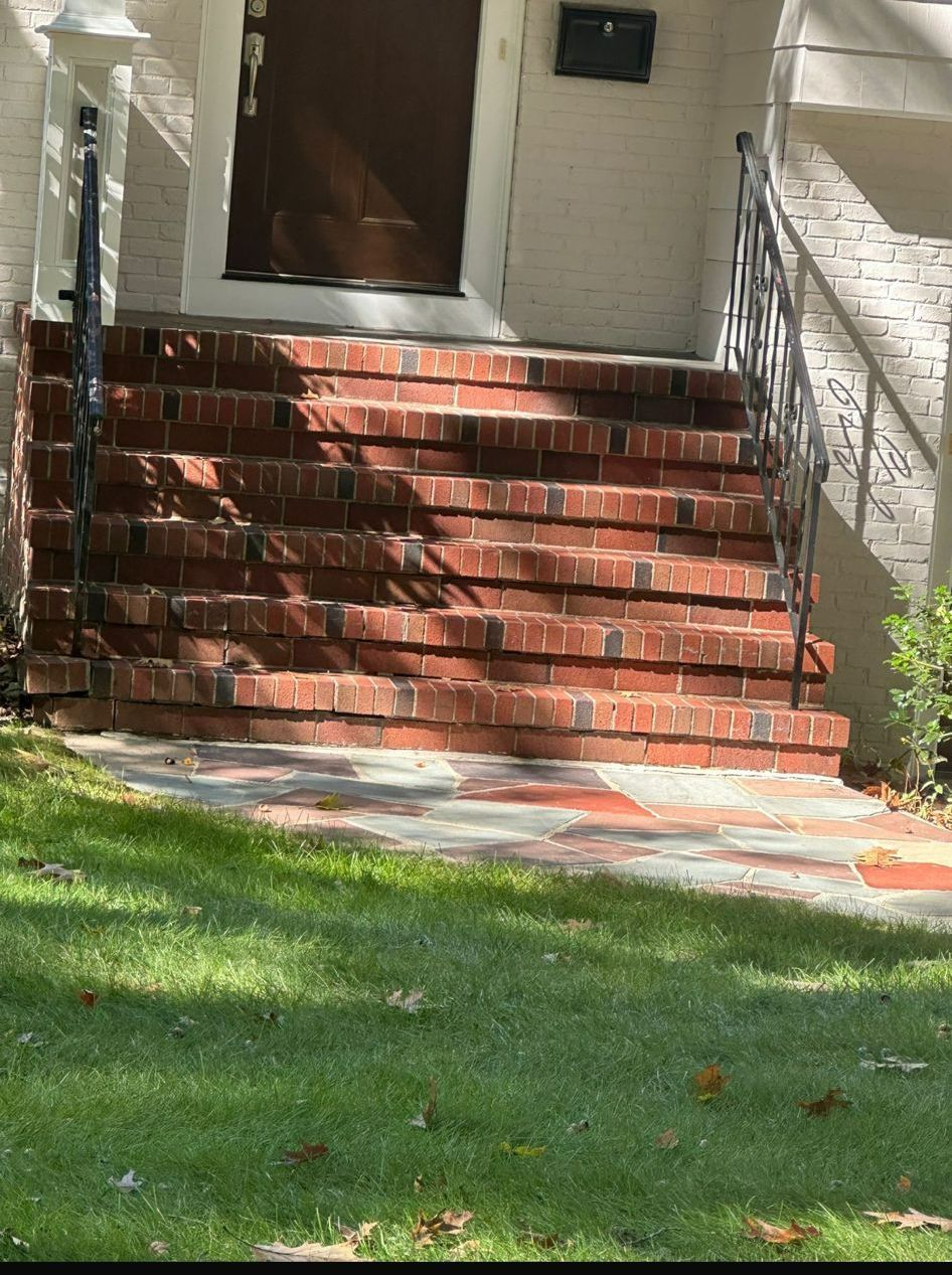 A set of brick stairs leading up to the front door of a house