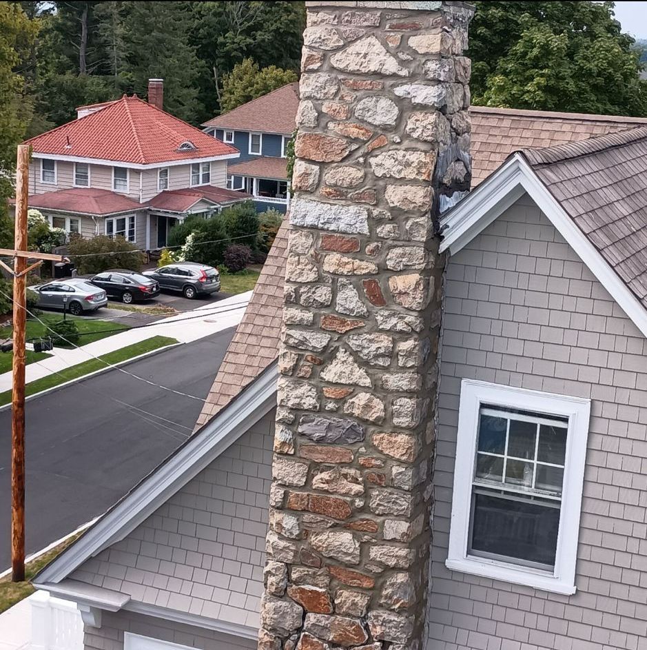 An aerial view of a house with a chimney and a window