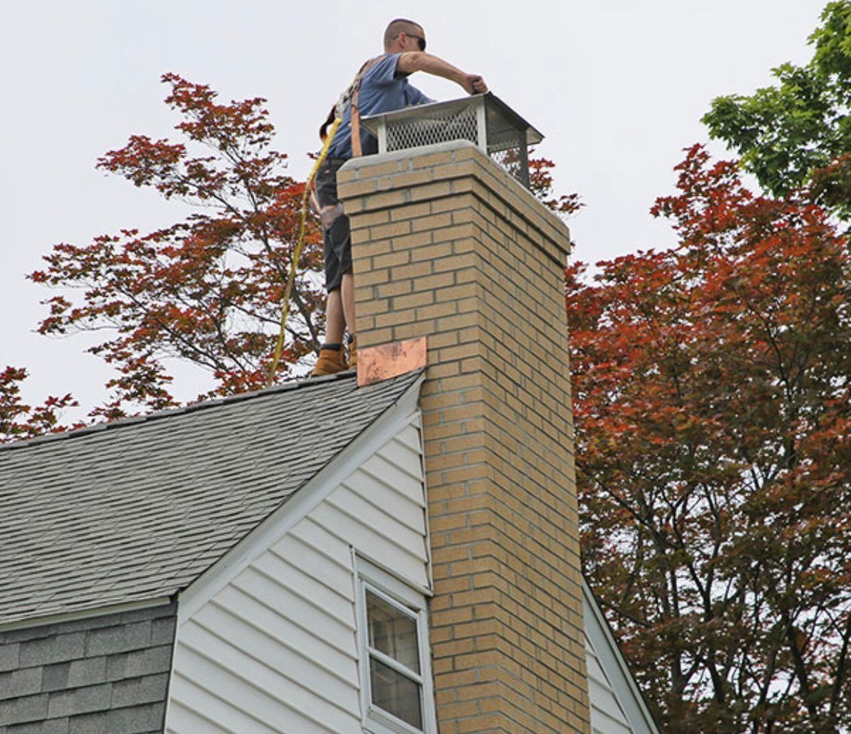 Mason repairing the chimney