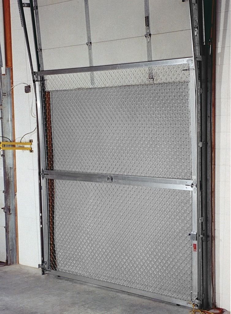 A garage door with a chain link fence behind it