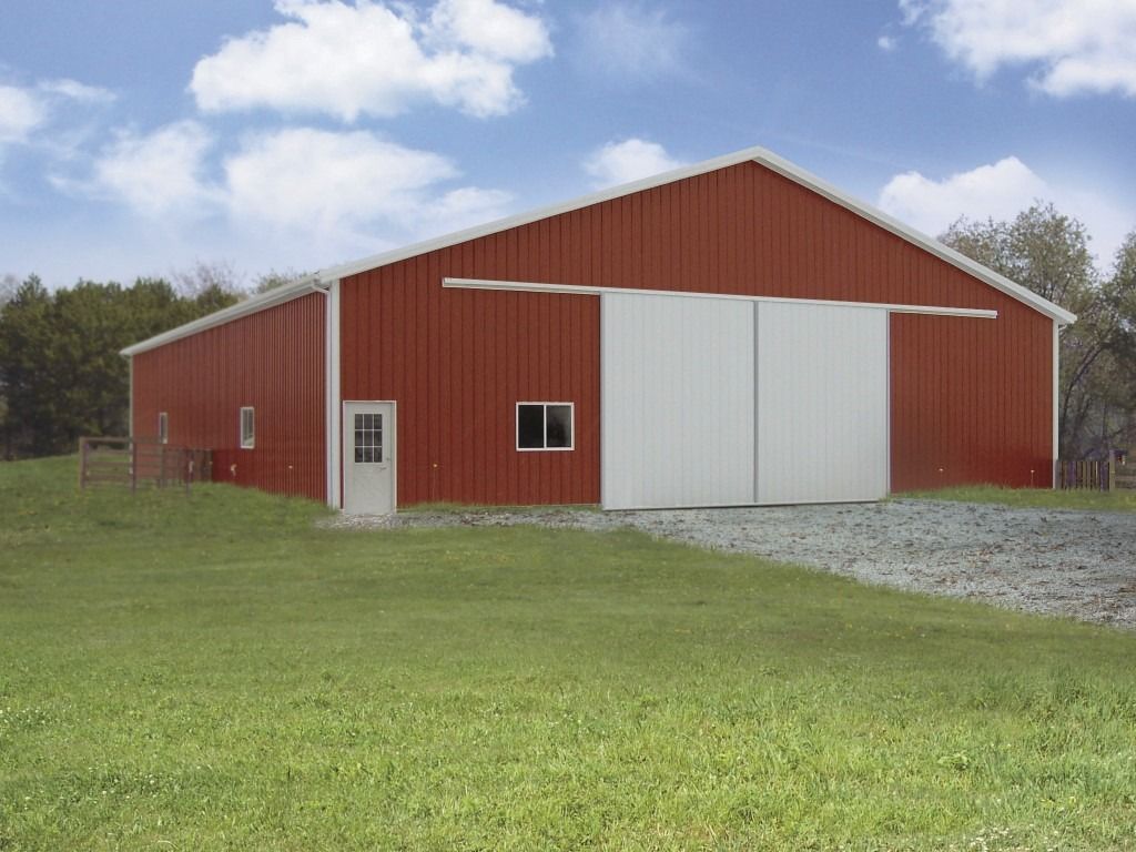 A large red barn with white trim and sliding doors