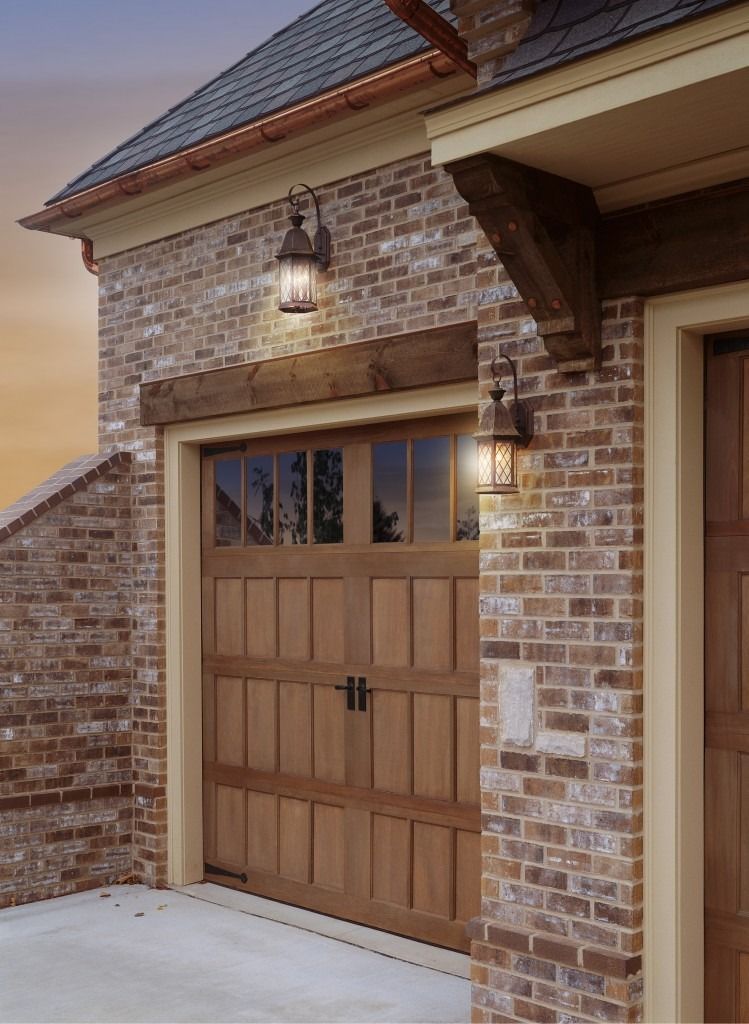 A brick building with a wooden garage door