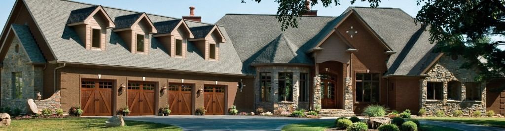 A large brick house with a lot of garage doors