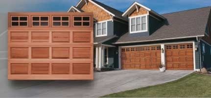 A picture of a house with a wooden garage door