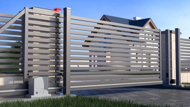 A sliding gate is open in front of a house